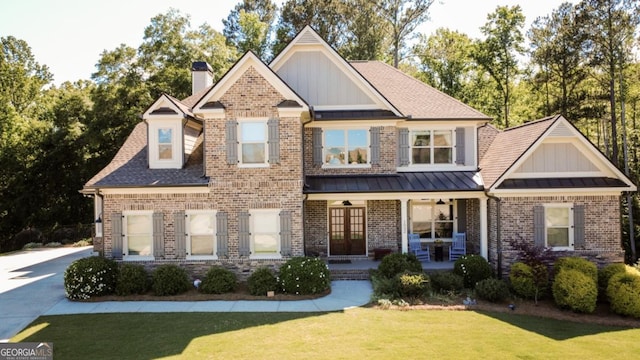 1032 Switchgrass Dr, Statham, GA 30666 - craftsman-style house featuring brick siding, a front lawn, a porch, and french doors