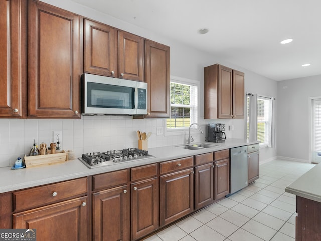 1613 Brolington Ct, Conyers, GA 30013 - kitchen featuring appliances with stainless steel finishes, light tile patterned floors, decorative backsplash, light countertops, and recessed lighting