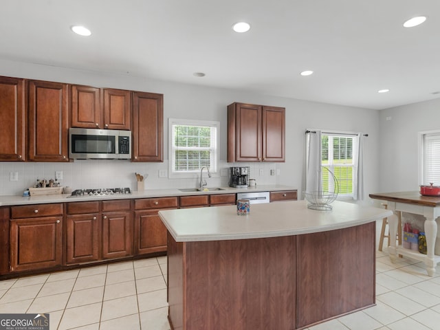 1613 Brolington Ct, Conyers, GA 30013 - kitchen with stainless steel appliances, light countertops, light tile patterned flooring, healthy amount of natural light, and recessed lighting
