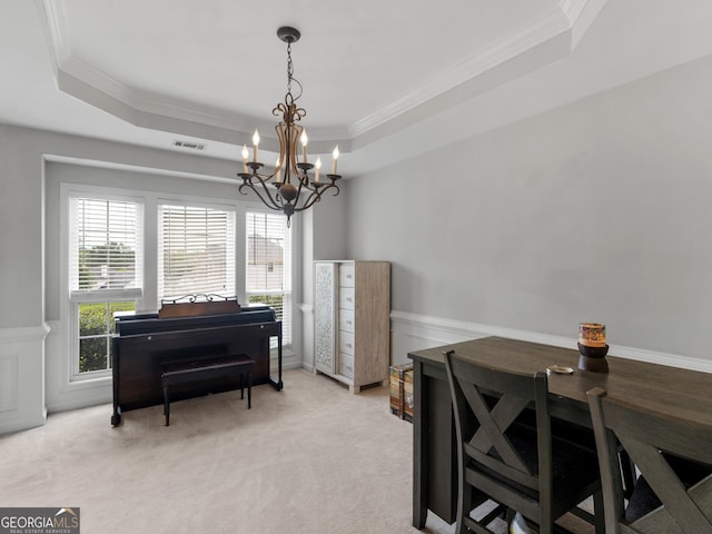 1613 Brolington Ct, Conyers, GA 30013 - dining space featuring ornamental molding, a raised ceiling, a chandelier, light carpet, and wainscoting