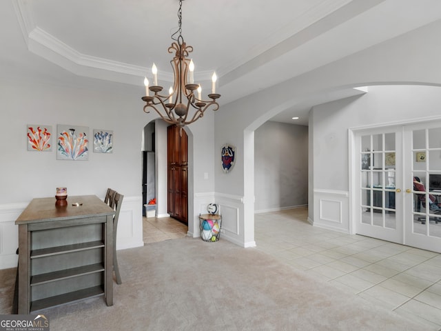1613 Brolington Ct, Conyers, GA 30013 - dining space featuring arched walkways, ornamental molding, light tile patterned floors, a decorative wall, and a wainscoted wall