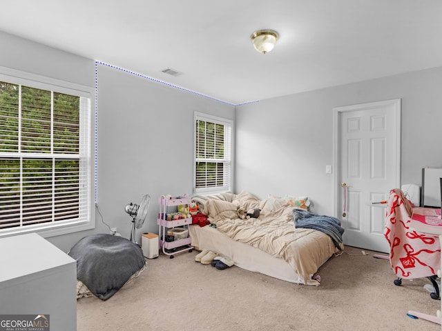 1613 Brolington Ct, Conyers, GA 30013 - bedroom featuring carpet flooring and multiple windows
