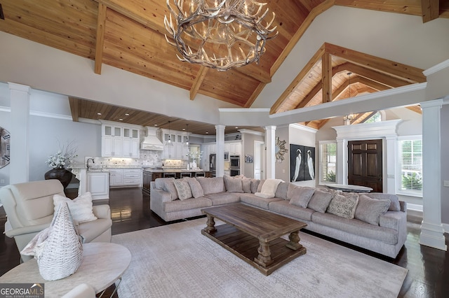 177 Selfridge Rd, Mcdonough, GA 30252 - living area with decorative columns, dark wood-type flooring, a wood ceiling with exposed beams, a chandelier, and high vaulted ceiling
