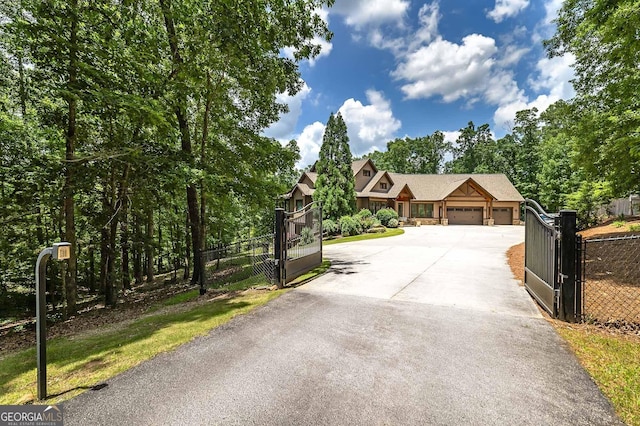 177 Selfridge Rd, Mcdonough, GA 30252 - view of front facade featuring a garage, a gate, concrete driveway, and stone siding
