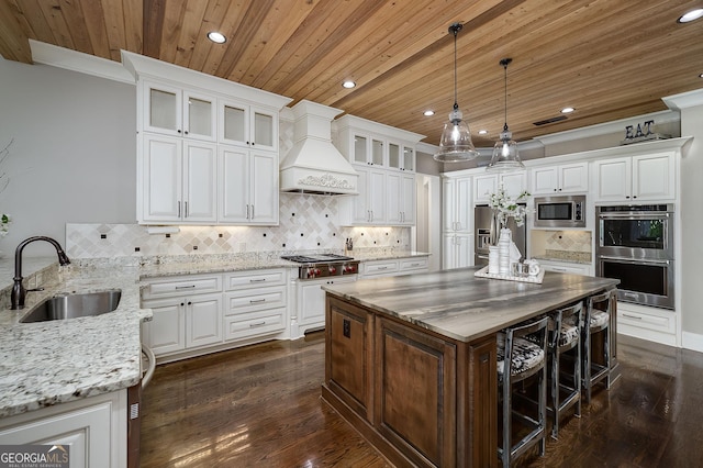 177 Selfridge Rd, Mcdonough, GA 30252 - kitchen with appliances with stainless steel finishes, recessed lighting, custom exhaust hood, wood ceiling, and white cabinetry