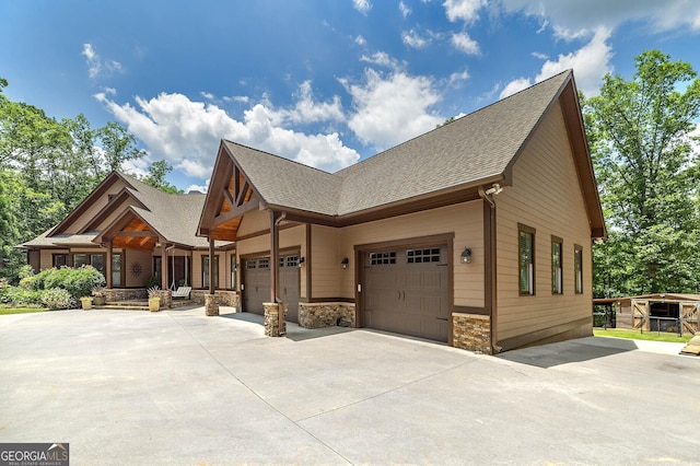 177 Selfridge Rd, Mcdonough, GA 30252 - view of front of house featuring driveway, roof with shingles, stone siding, and a garage