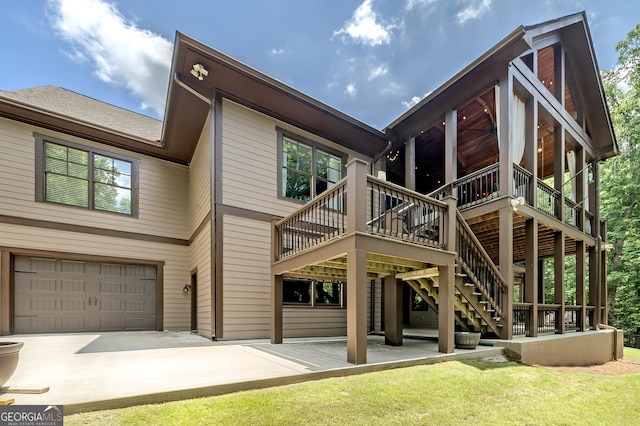 177 Selfridge Rd, Mcdonough, GA 30252 - back of property with an attached garage, a yard, concrete driveway, a wooden deck, and stairway