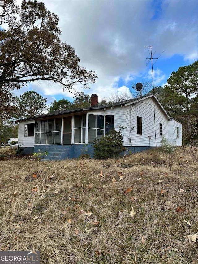 796 Shoemaker Rd, West Point, GA 31833 - view of front of house with a sunroom and a chimney