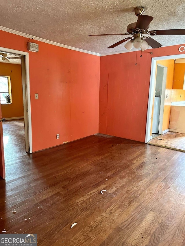 796 Shoemaker Rd, West Point, GA 31833 - empty room featuring a textured ceiling, wood finished floors, crown molding, ceiling fan, and wooden walls