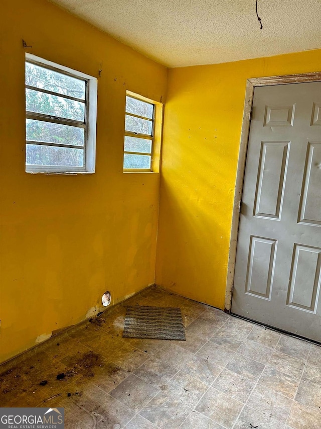 796 Shoemaker Rd, West Point, GA 31833 - spare room with a textured ceiling and stone finish flooring