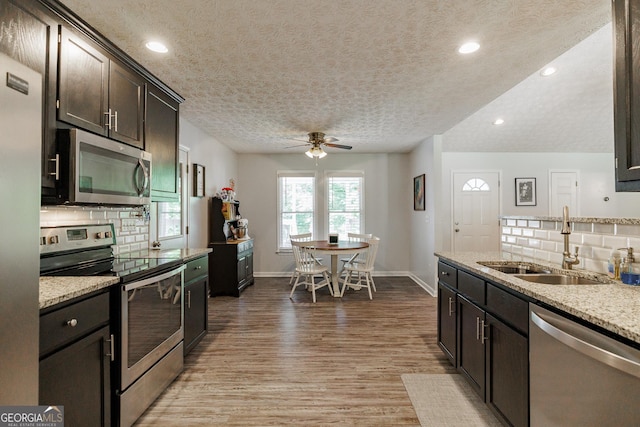 82 Post Oak Cir, Crawford, GA 30630 - kitchen featuring appliances with stainless steel finishes, a sink, backsplash, wood finished floors, and recessed lighting