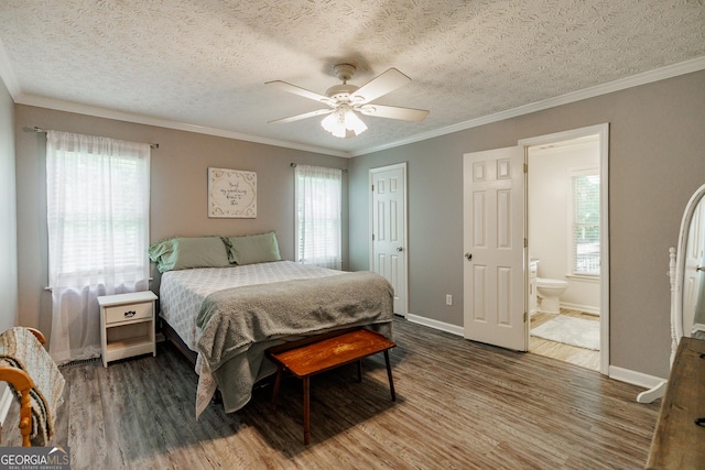 82 Post Oak Cir, Crawford, GA 30630 - bedroom featuring wood finished floors, multiple windows, crown molding, a textured ceiling, and baseboards