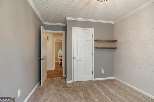 82 Post Oak Cir, Crawford, GA 30630 - unfurnished bedroom featuring wooden walls, carpet floors, baseboards, crown molding, and a textured ceiling