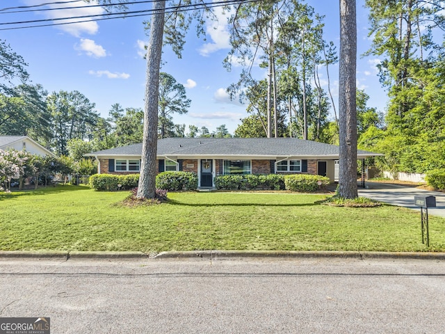 3182 Willow Creek Rd, Augusta, GA 30909 - single story home with driveway, brick siding, an attached carport, and a front lawn
