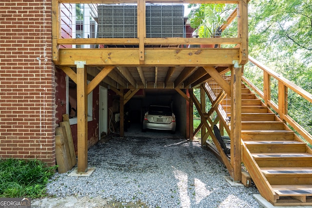 278 Fourth St, Athens, GA 30601 - view of vehicle parking featuring stairway, gravel driveway, and a carport