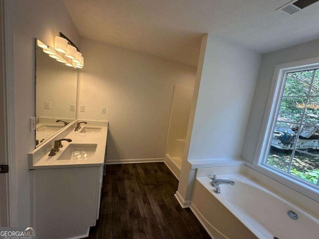 11 Long Branch Xing, Dahlonega, GA 30533 - full bath featuring wood finished floors, double vanity, a bath, baseboards, and a textured ceiling