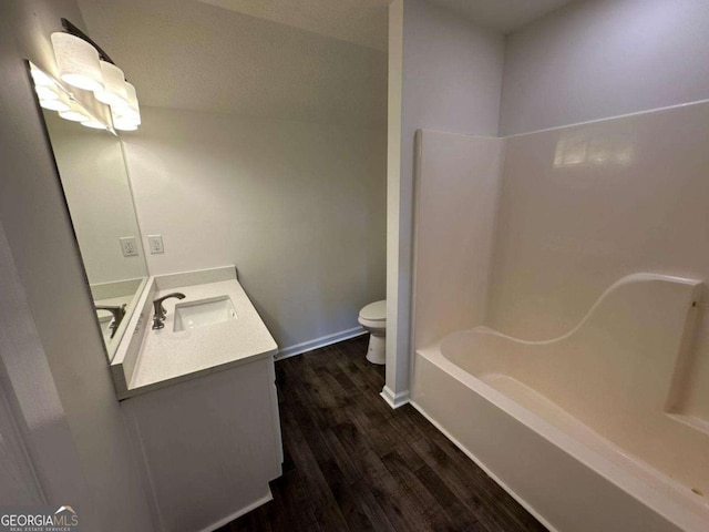 11 Long Branch Xing, Dahlonega, GA 30533 - full bathroom featuring wood finished floors, toilet, vanity, bathtub / shower combination, and baseboards