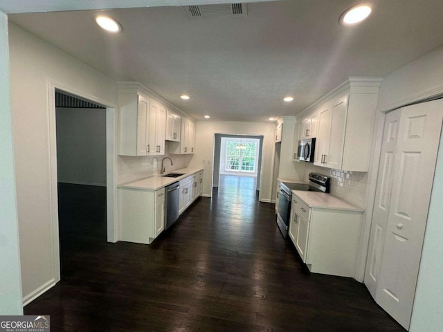 11 Long Branch Xing, Dahlonega, GA 30533 - kitchen featuring appliances with stainless steel finishes, dark wood finished floors, light countertops, decorative backsplash, and recessed lighting