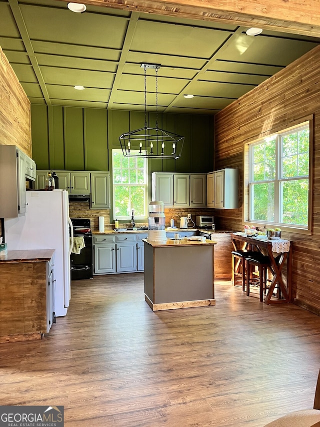 1048 Whites Mill Rd, Valley, AL 36854 - kitchen with range, healthy amount of natural light, wood walls, a sink, and a kitchen island