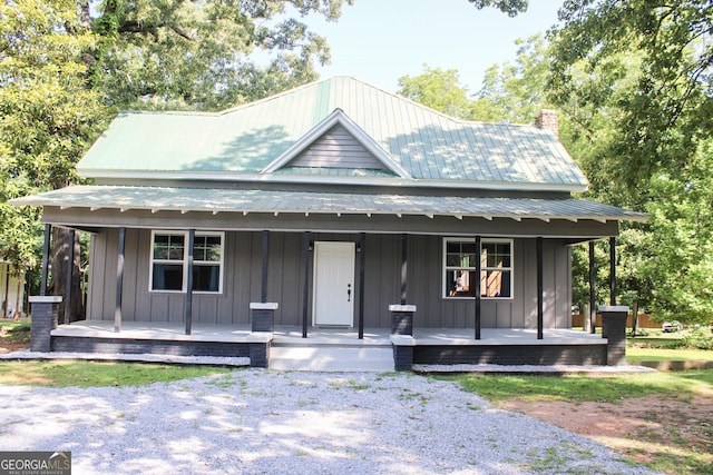 1048 Whites Mill Rd, Valley, AL 36854 - view of front of home featuring a porch, a chimney, board and batten siding, and metal roof