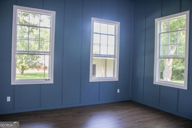 1048 Whites Mill Rd, Valley, AL 36854 - empty room featuring a decorative wall, dark wood finished floors, and plenty of natural light