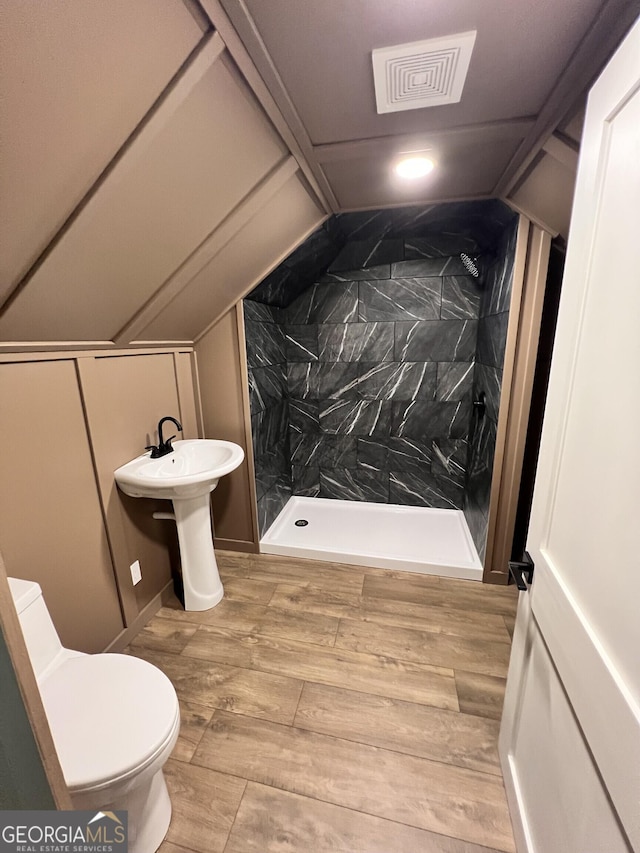 1048 Whites Mill Rd, Valley, AL 36854 - bathroom featuring a shower stall, toilet, lofted ceiling, and wood finished floors