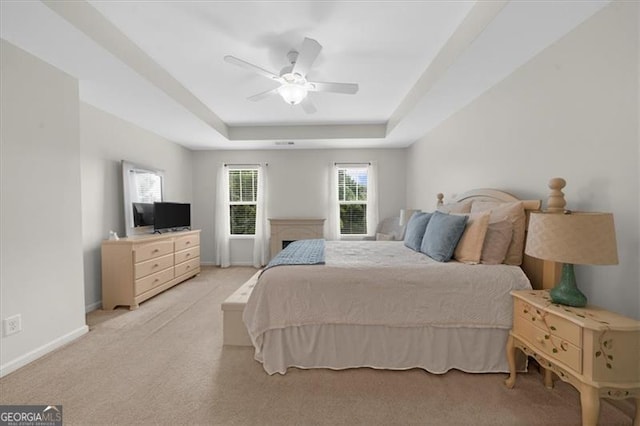 397 Cypher Dr, Suwanee, GA 30024 - bedroom featuring a tray ceiling, light colored carpet, and a ceiling fan