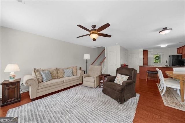 397 Cypher Dr, Suwanee, GA 30024 - living area featuring wood finished floors, a ceiling fan, and stairway