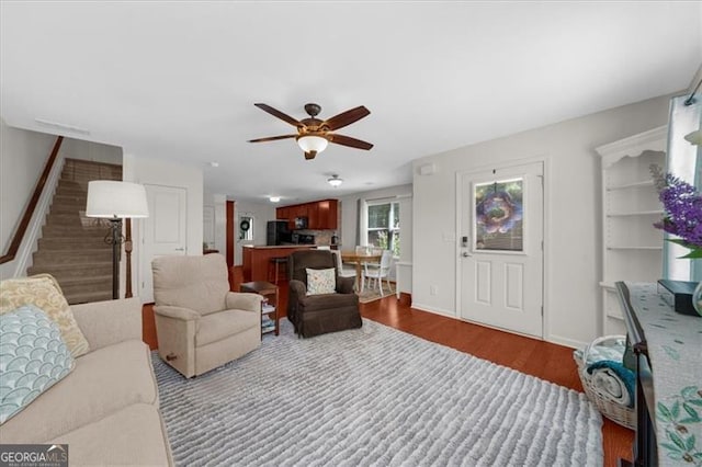 397 Cypher Dr, Suwanee, GA 30024 - living room with stairs, a ceiling fan, and dark wood-style flooring
