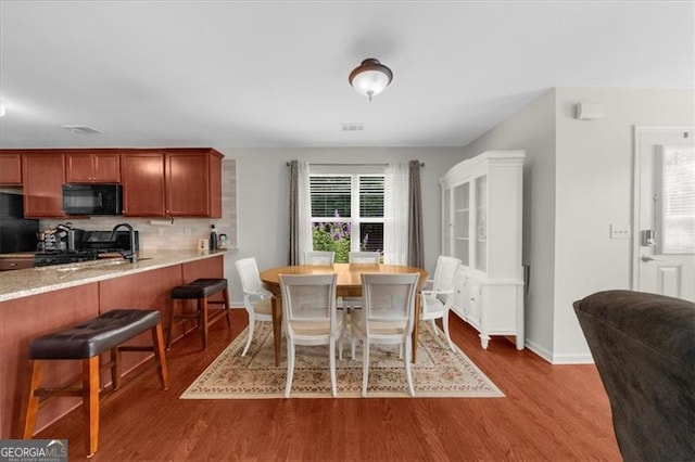 397 Cypher Dr, Suwanee, GA 30024 - dining room with dark wood-style flooring and baseboards