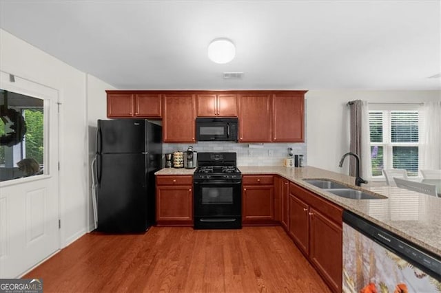 397 Cypher Dr, Suwanee, GA 30024 - kitchen featuring black appliances, wood finished floors, backsplash, and plenty of natural light