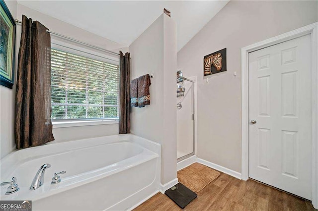 9410 Brooke Cove Ct, Gainesville, GA 30506 - full bath with vaulted ceiling, a garden tub, wood finished floors, baseboards, and a shower stall