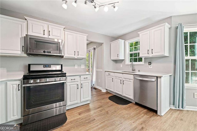 9410 Brooke Cove Ct, Gainesville, GA 30506 - kitchen with appliances with stainless steel finishes, a sink, and light countertops