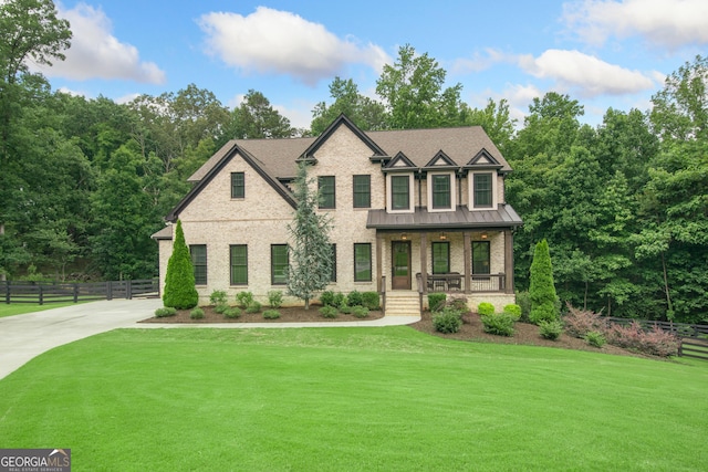 1935 Freemanville Crossing Ct, Milton, GA 30004 - view of front of home with a porch, brick siding, a standing seam roof, driveway, and a metal roof