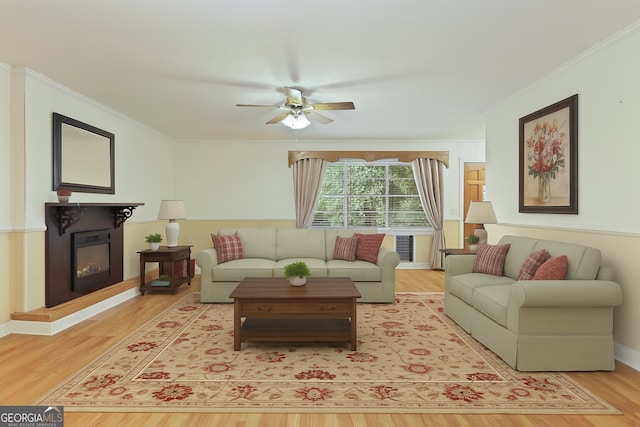 2317 Ga Highway 24, Statesboro, GA 30461 - living area with wood finished floors, a glass covered fireplace, a ceiling fan, and crown molding