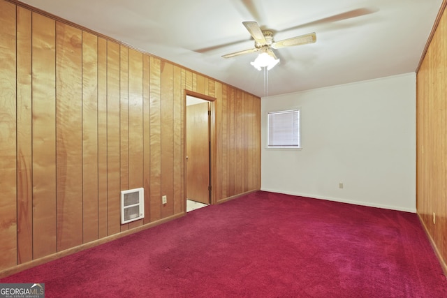 2317 Ga Highway 24, Statesboro, GA 30461 - unfurnished bedroom with wooden walls, heating unit, carpet, and ceiling fan