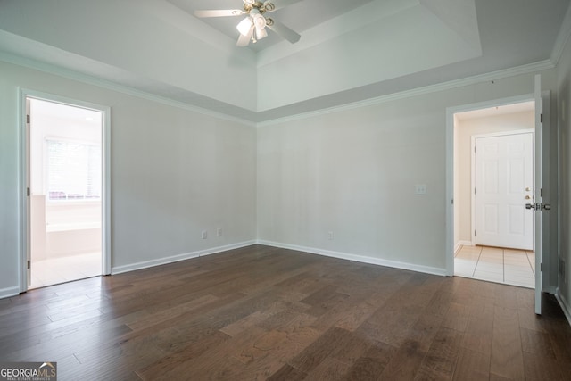 2021 Windfield Dr, Monroe, GA 30655 - unfurnished room with dark wood finished floors, a ceiling fan, a tray ceiling, and crown molding
