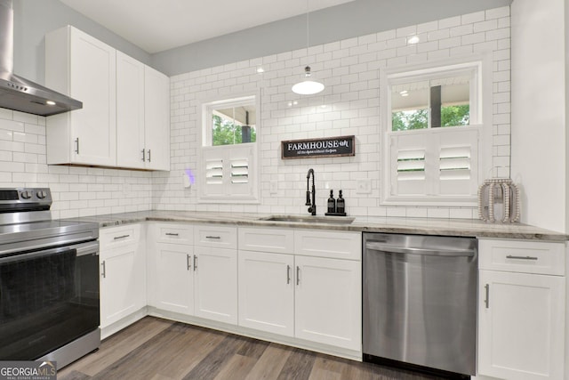 92 Autumn Path, Rockmart, GA 30153 - kitchen with appliances with stainless steel finishes, wall chimney range hood, decorative backsplash, and white cabinetry