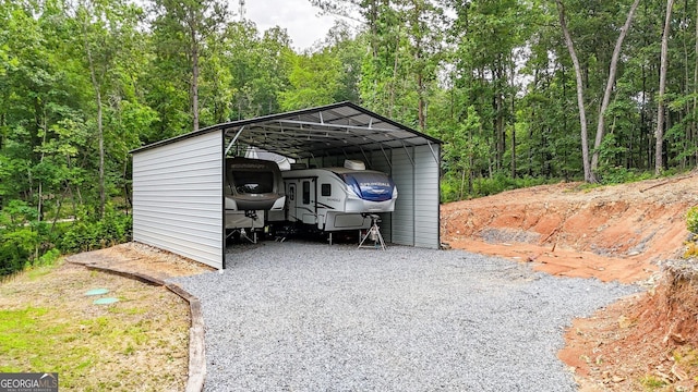 92 Autumn Path, Rockmart, GA 30153 - view of car parking featuring a detached carport, a forest view, and driveway