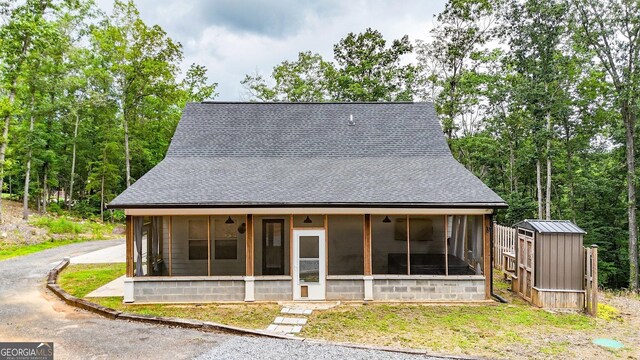 92 Autumn Path, Rockmart, GA 30153 - view of front facade with roof with shingles, a sunroom, and a storage unit