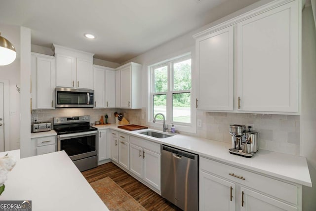230 Lake St, Athens, GA 30601 - kitchen with appliances with stainless steel finishes, a sink, white cabinetry, dark wood-style floors, and light countertops