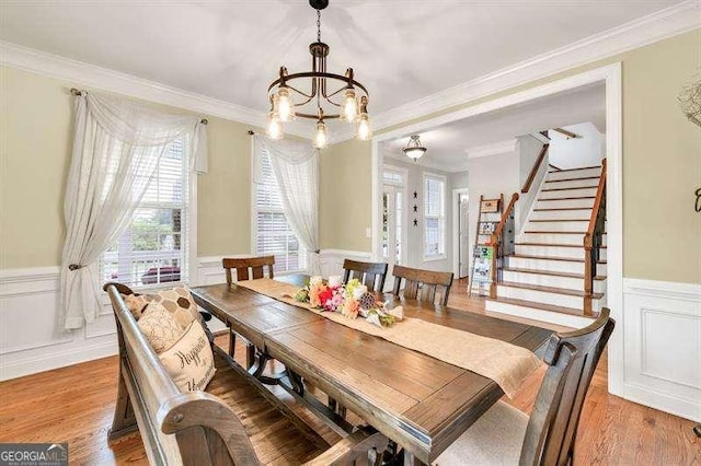 125 Shamus Way, Jefferson, GA 30549 - dining space with a chandelier, a decorative wall, a wainscoted wall, ornamental molding, and light wood-style floors