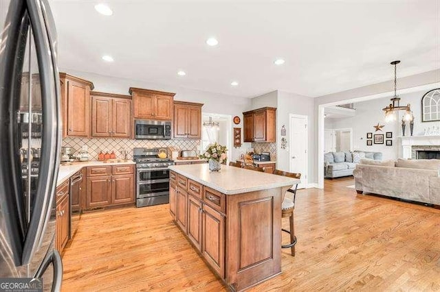 125 Shamus Way, Jefferson, GA 30549 - kitchen featuring stainless steel appliances, a center island, open floor plan, backsplash, and recessed lighting