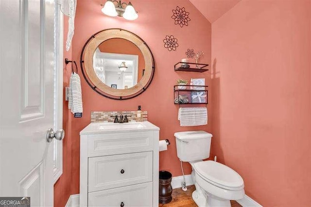 125 Shamus Way, Jefferson, GA 30549 - half bath with vanity, vaulted ceiling, and decorative backsplash