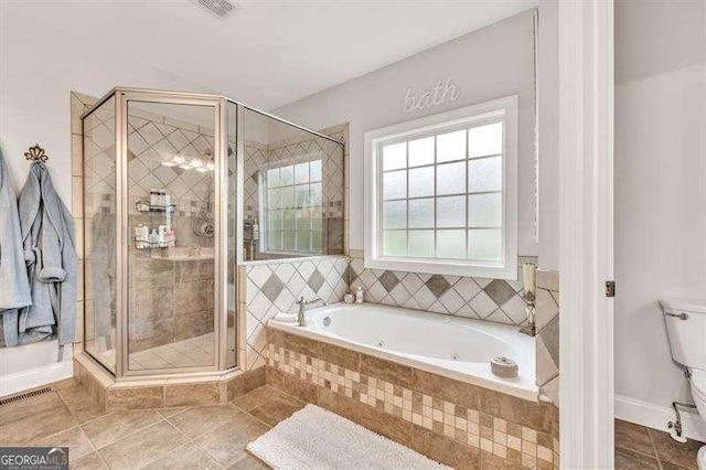 125 Shamus Way, Jefferson, GA 30549 - bathroom featuring a tub with jets, a stall shower, and tile patterned floors