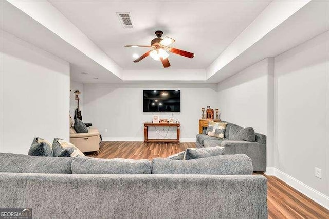 125 Shamus Way, Jefferson, GA 30549 - living area featuring ceiling fan, a tray ceiling, and wood finished floors