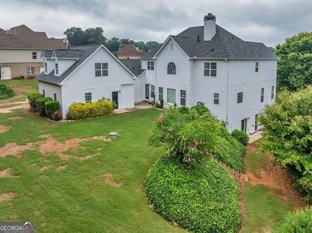 125 Shamus Way, Jefferson, GA 30549 - back of house featuring a lawn and a chimney