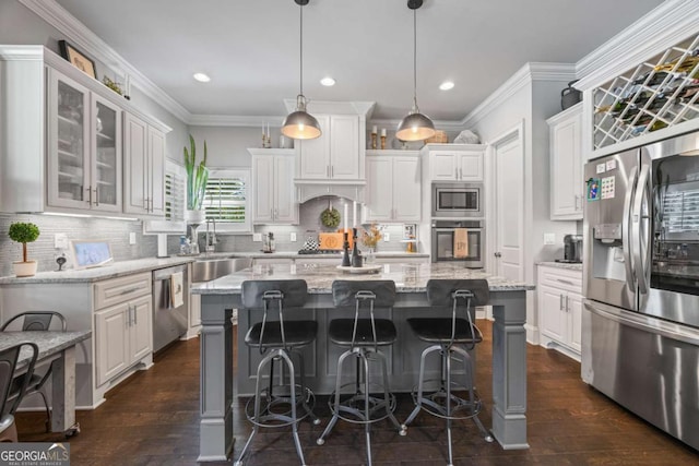 3111 Old Thompson Mill Rd, Buford, GA 30519 - kitchen with stainless steel appliances, white cabinetry, dark wood finished floors, recessed lighting, and crown molding