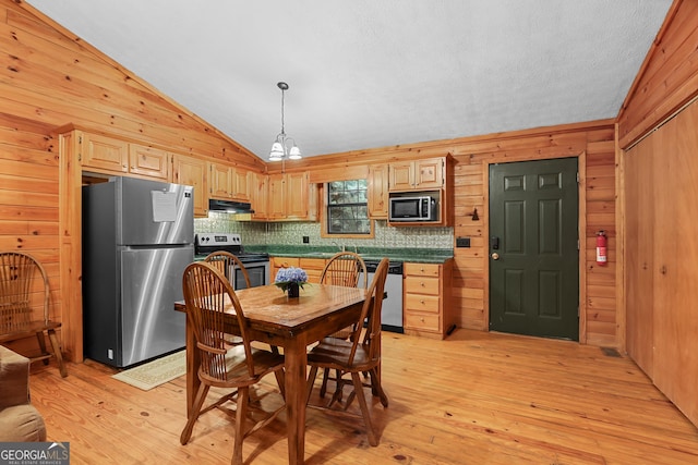 242 Eagles Nest Rd, Sautee Nacoochee, GA 30571 - kitchen featuring appliances with stainless steel finishes, under cabinet range hood, light brown cabinetry, vaulted ceiling, and light wood-type flooring