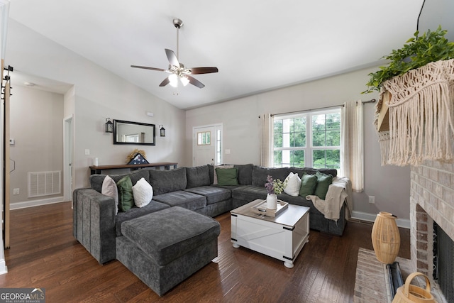 521 Peeples Valley Rd NW, Cartersville, GA 30121 - living room with dark wood-style flooring, ceiling fan, lofted ceiling, and a brick fireplace